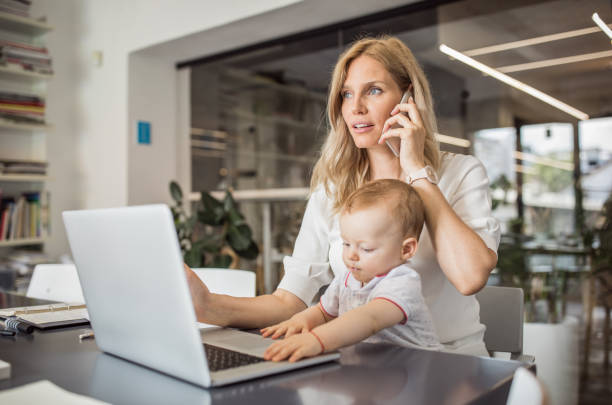 istock Single mother with baby working in office 1064530728