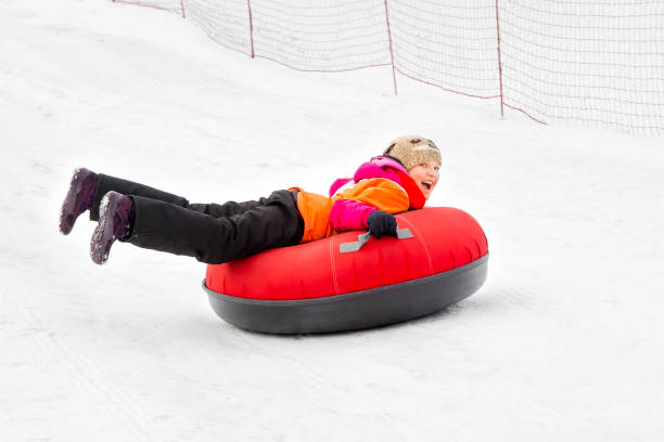 istock Girl Snowtubes Downhill 1064532704