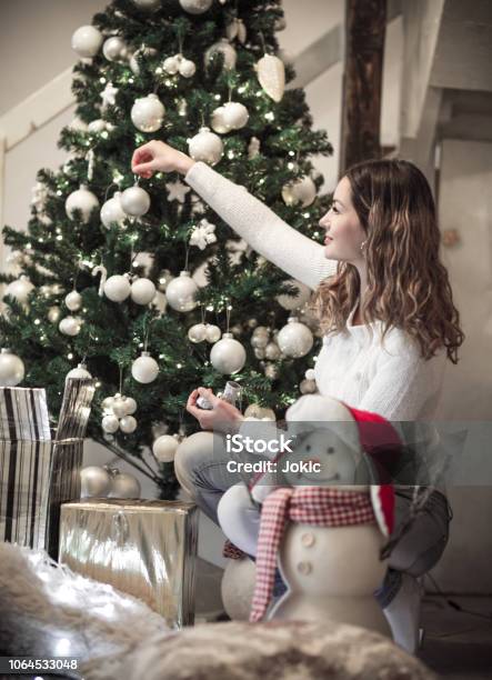 One Girl Decorating Christmas Tree Stock Photo - Download Image Now - 2018, 2019, 30-39 Years