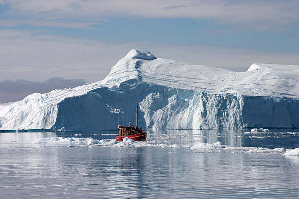 Boat in front of iceberg  ilulissat icefjord stock pictures, royalty-free photos & images