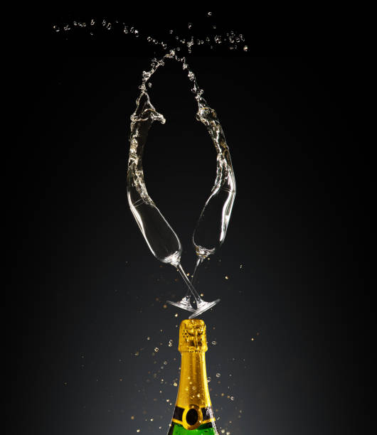 istock Goblets with champagne bottle and splashes 1064533830