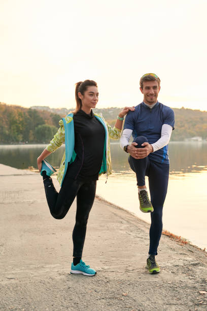 istock Young man and woman stretching before running 1064536640