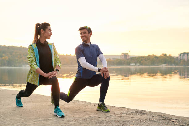 istock Young man and woman stretching before running 1064536700