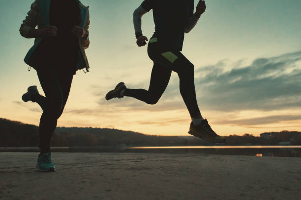 istock Sportive people legs running at sunrise 1064536822