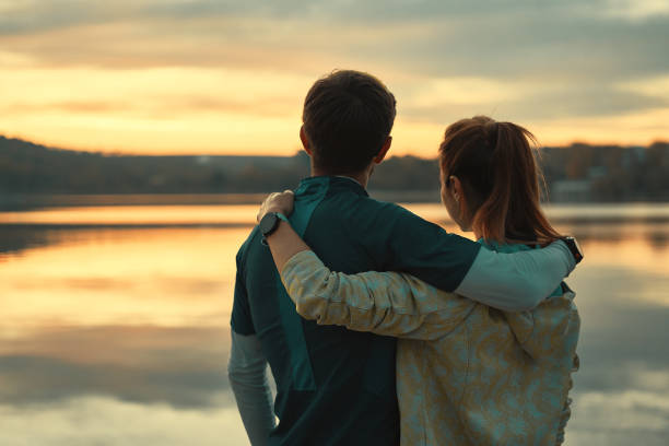 istock Happy romantic fit young couple enjoying sunset 1064536850
