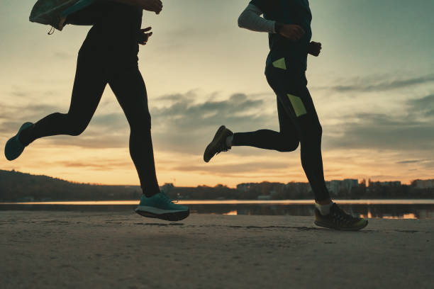 istock Sportive people legs running at sunrise 1064536880