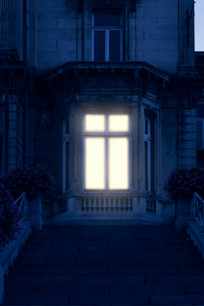 Illuminated window of historical mansion.