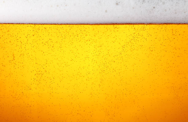 close up background of beer with bubbles in glass - lager beer imagens e fotografias de stock