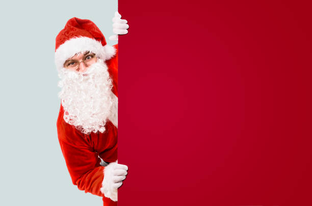 istock Santa Claus with colorful advertisement board 1064540850