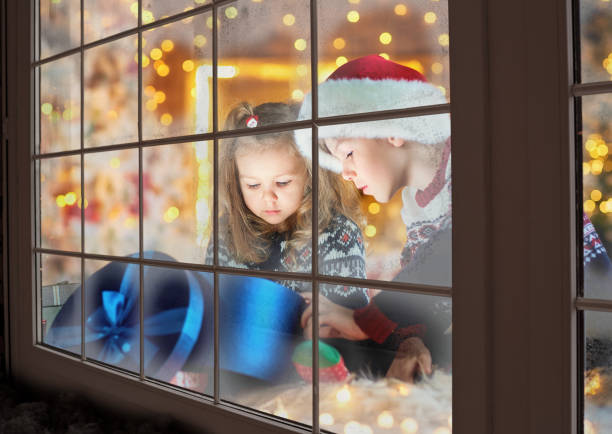 istock Children in a santa hat playing on Christmas Day. 1064541090