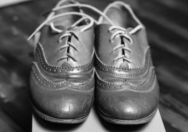 a pair of worn and dirty shoes isolated on pink