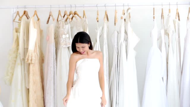Asian women cheerful happiness in wedding fashion store