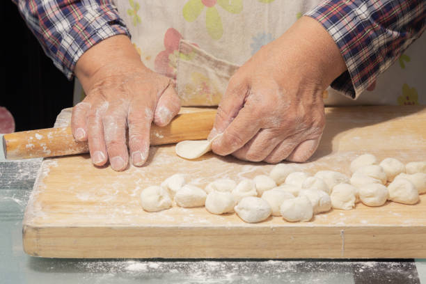 istock A pair of mother's hands are making dumplings 1064542628