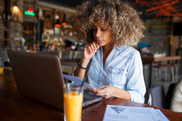 istock Focused young African woman working online in a cafe 1064543808