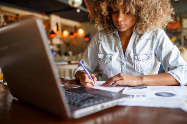 istock Focused young African woman working online in a cafe 1064544976