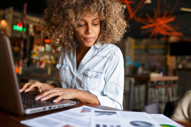 istock Focused young African woman working online in a cafe 1064545050