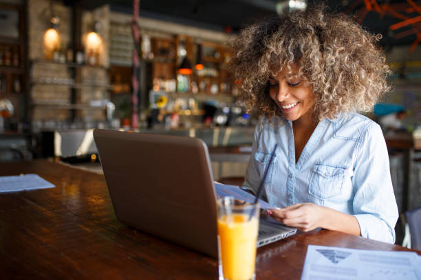 istock Focused young African woman working online in a cafe 1064545160