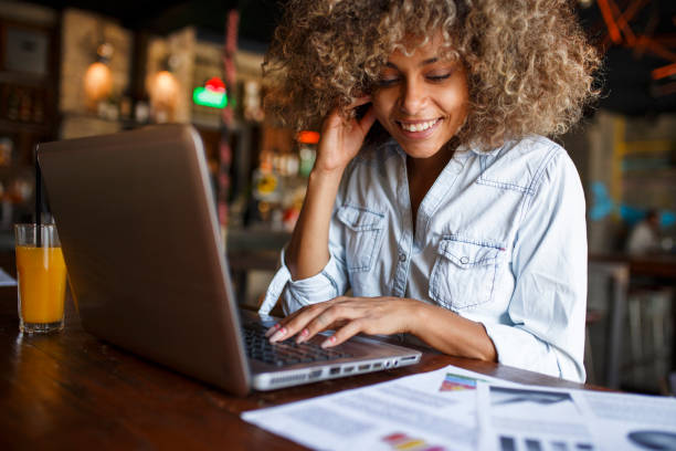 istock Focused young African woman working online in a cafe 1064545246