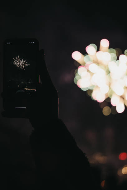 people taking photos of fireworks on guy fawkes night in alexandra palace, london, uk. - firework display pyrotechnics london england silhouette imagens e fotografias de stock