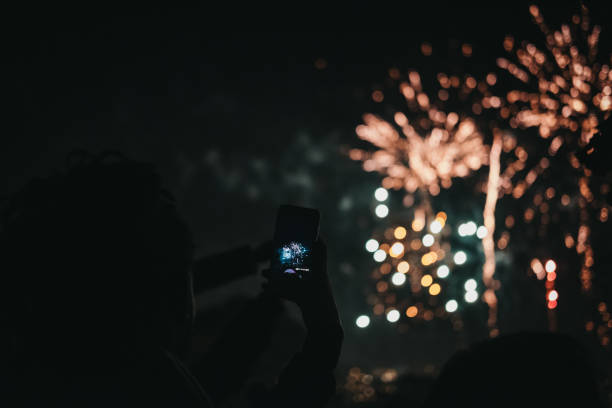 people taking photos of fireworks on guy fawkes night in alexandra palace, london, uk. - firework display pyrotechnics london england silhouette imagens e fotografias de stock