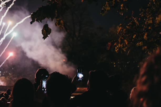 people taking photos of fireworks on guy fawkes night in alexandra palace, london, uk. - firework display pyrotechnics london england silhouette imagens e fotografias de stock