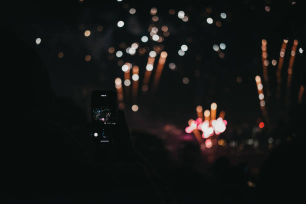 people taking photos of fireworks on guy fawkes night in alexandra palace, london, uk. - firework display pyrotechnics london england silhouette imagens e fotografias de stock
