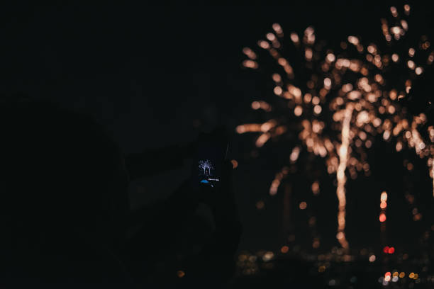 people taking photos of fireworks on guy fawkes night in alexandra palace, london, uk. - firework display pyrotechnics london england silhouette imagens e fotografias de stock