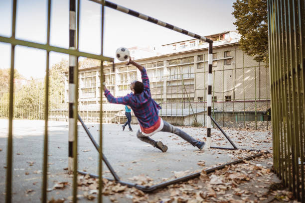 istock Father and son playing soccer outdoors 1064547022