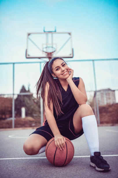 istock Cute Female Basketball Player Posing In Kneeling Position 1064547056
