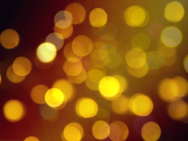 istock golden yellow round blurred lights on a dark background 1064547106