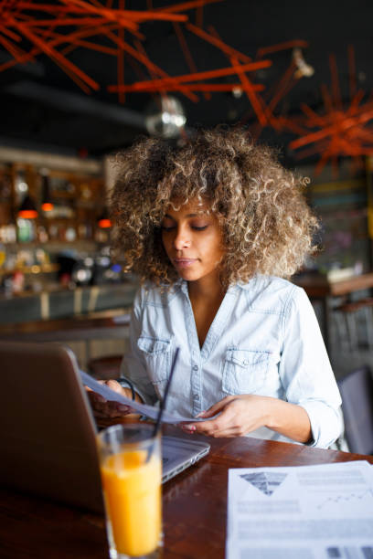 istock Focused young African woman working online in a cafe 1064547326