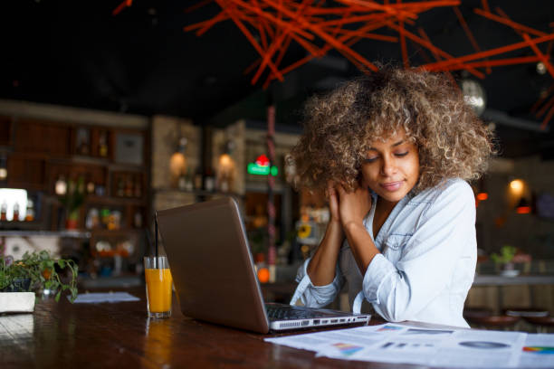 istock Focused young African woman working online in a cafe 1064547704