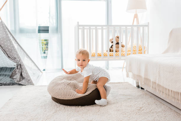 istock adorable toddler in white nursery room 1064547714