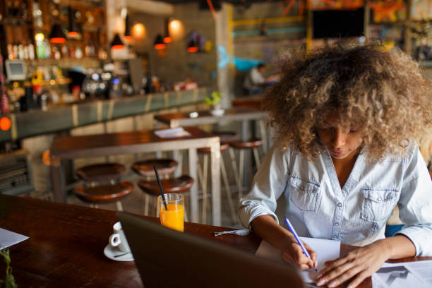 istock Focused young African woman working online in a cafe 1064548086