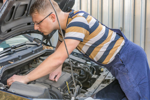 istock Mechanic looks at the engine compartment of a car 1064549298