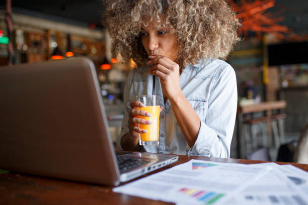 istock Focused young African woman working online in a cafe 1064549404