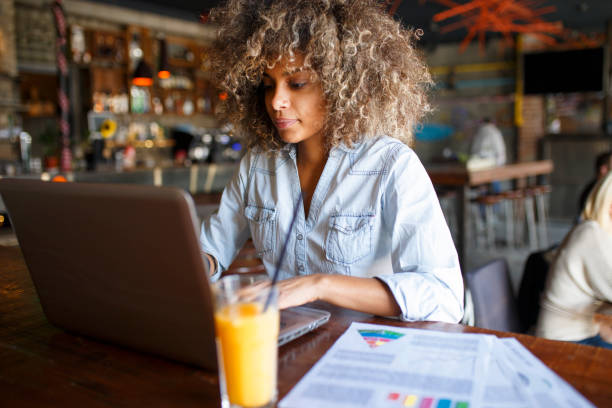 istock Focused young African woman working online in a cafe 1064549490