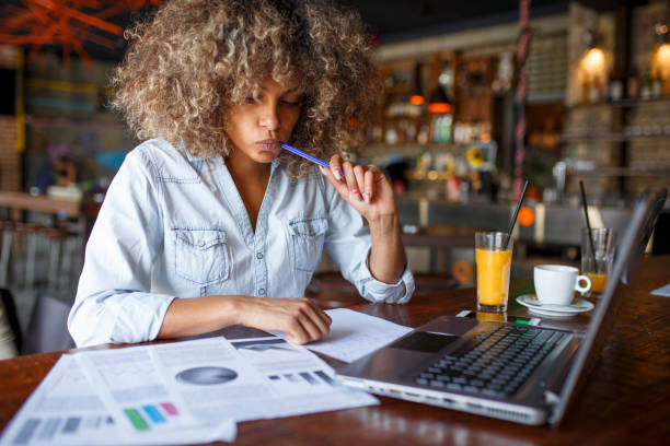 istock Focused young African woman working online in a cafe 1064549622