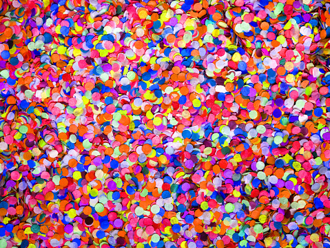 Confetti diversity background, large size. Texture colored circles from paper, close-up. Basis for a festive design or a postcard. Carnival, abstract wedding or birthday backdrop
