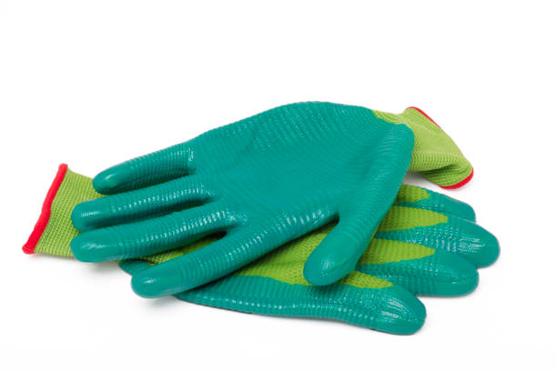 Manual Labor: Old Yellow Leather Work Glove on Plywood Background