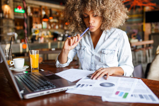 istock Focused young African woman working online in a cafe 1064550324