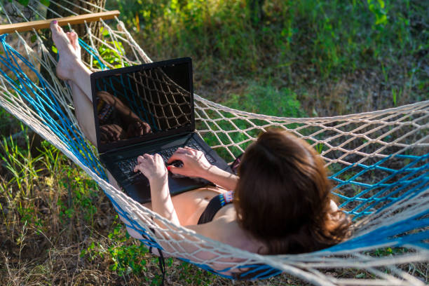 istock Business woman working on laptop while on vacation. 1064550902