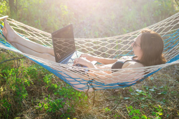 Woman workaholic working on vacation, space.