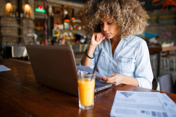 istock Focused young African woman working online in a cafe 1064552150