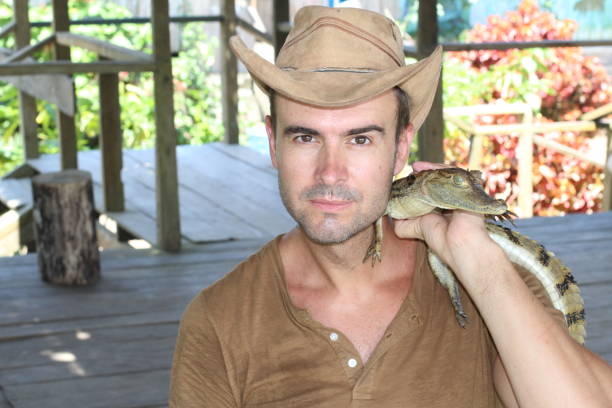 istock Man holding baby reptile with copy space 1064552338