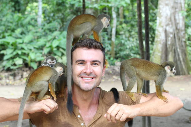 istock Handsome man with titi monkey's group 1064552394