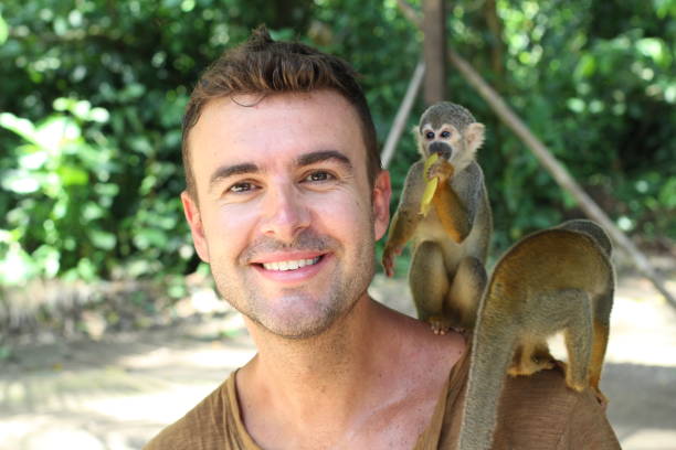 istock Man establishing in contact with monkeys 1064552402