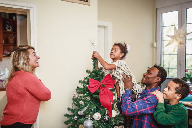 istock Mixed race family decorating home for Christmas 1064555596