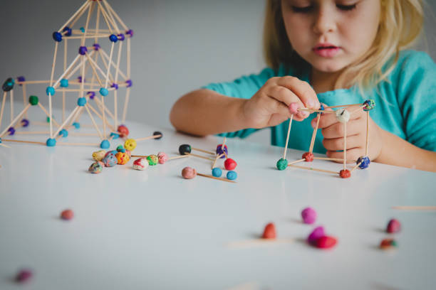 istock little girl making geometric shapes, engineering and STEM 1064555864