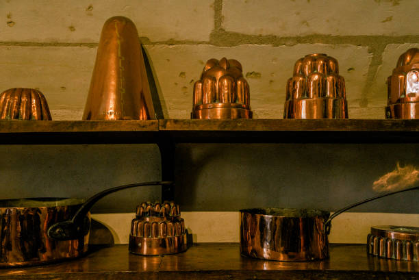 istock Vintage copper dishware on wooden shelves 1064556852